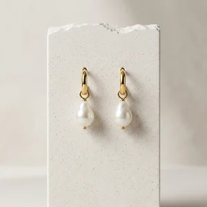 Pearl earrings on textured paper