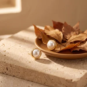Golden oak leaf jewelry on stone