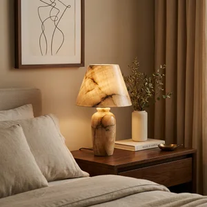Warm marble lamp on nightstand