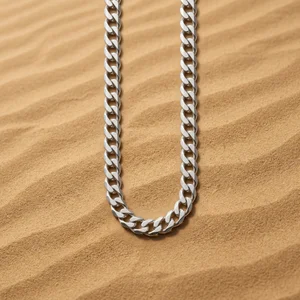 Silver chain on textured sand