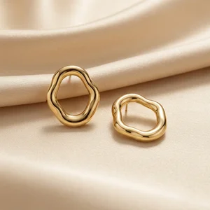 Elegant gold hoops on silk