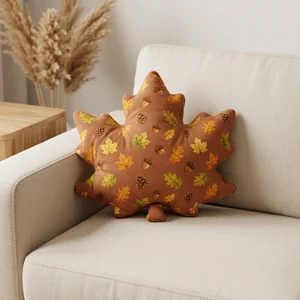Autumn leaf pillow on cozy couch