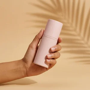 Hand holding bottle with palm shadow