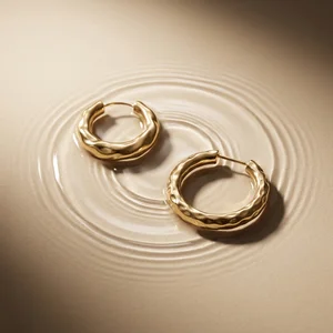 Gold hoops in water ripples