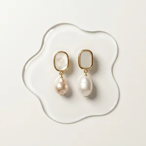Pearl earrings on water puddle