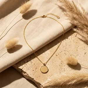 Elegant gold pendant on stone and linen