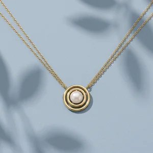 Gold pearl necklace on blue