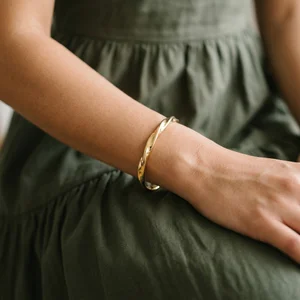Chic gold bangle on linen model