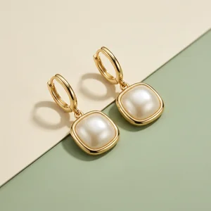 Modern pearl earrings on paper