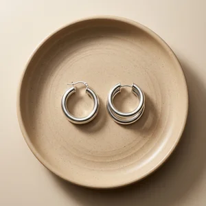 Silver hoop earrings on ceramic plate