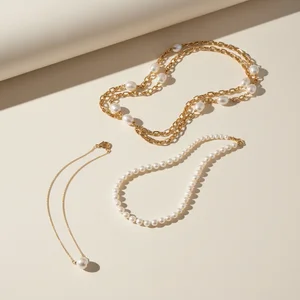 Layered pearl & gold necklaces