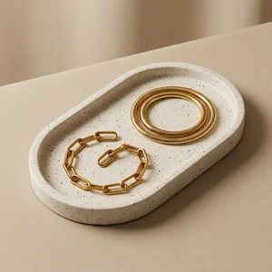Elegant gold jewelry on concrete tray