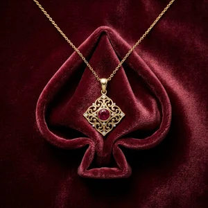 Luxury gold necklace on red velvet spade