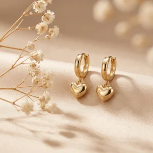 Elegant gold heart earrings on silk