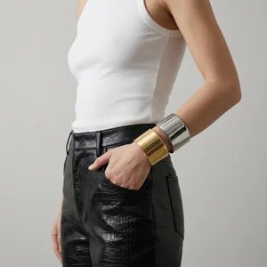 Bold mixed metal cuffs on model