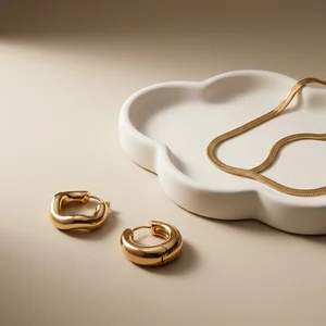 Gold jewelry on ceramic tray