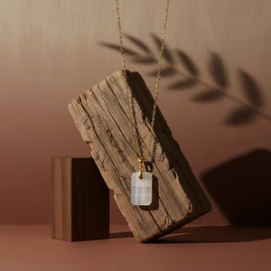 Gold pendant on wood