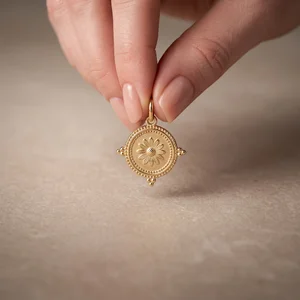 Gold palm tree pendant on stone