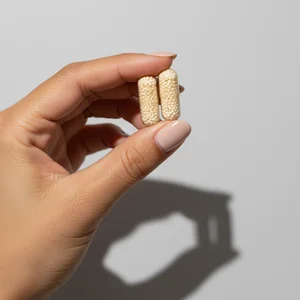 Vitamin capsule held by hand