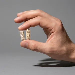 Vitamin capsule held by hand