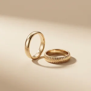 Elegant gold rings on beige