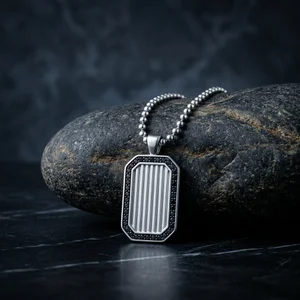 Men's dog tag necklace on black marble
