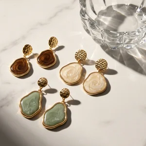 Sunlit resin earrings on marble