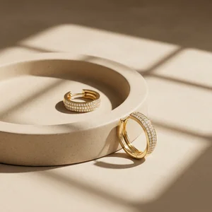 Elegant gold hoops on beige tray