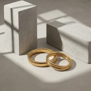Gold bracelets on concrete blocks
