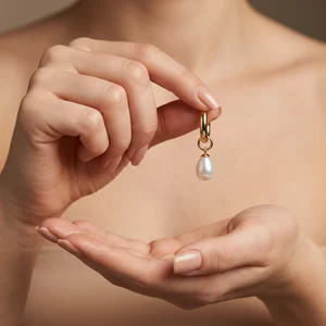 Elegant pearl earring in hand