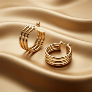 Luxury gold hoop earrings on silk
