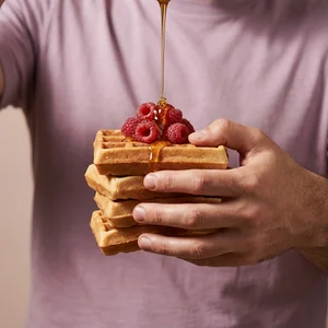 Waffles with raspberries and syrup