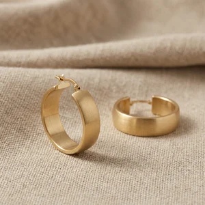 Matte gold hoops on linen