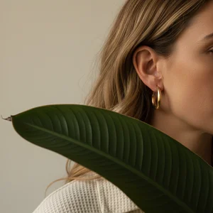 Golden hoop earring with foliage