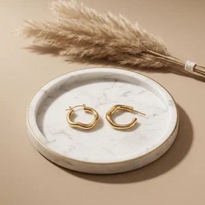 Elegant gold earrings on marble