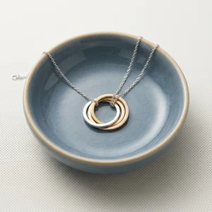 Minimalist jewelry in ceramic dish