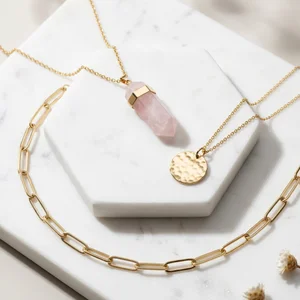 Layered gold necklaces on marble