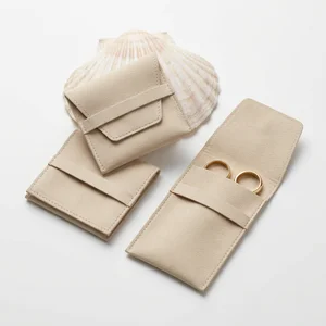 Beige suede pouches with seashell