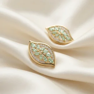 Elegant gold leaf earrings on silk