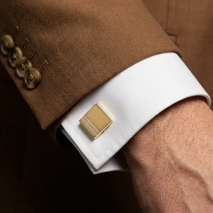 Classic gold cufflink on tweed