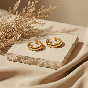 Elegant gold hoops on marble