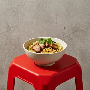 Crispy pork noodles on red stool