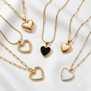 Elegant gold heart necklaces on silk