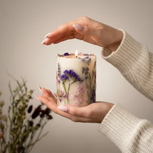 Cozy hands holding floral candle