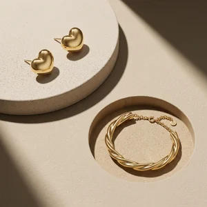Gold jewelry on textured beige
