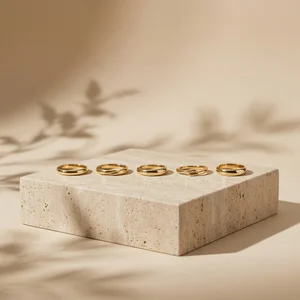 Gold rings on travertine stone