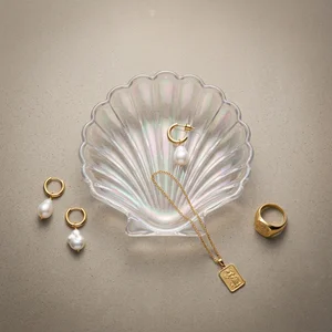 Gold and pearl jewelry on concrete