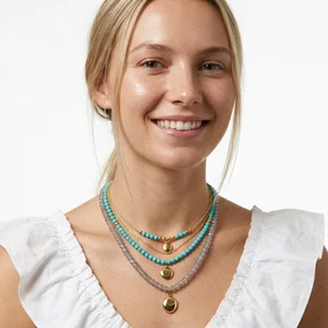 Layered bead & gold necklace on model