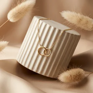 Elegant gold necklace on fluted stand