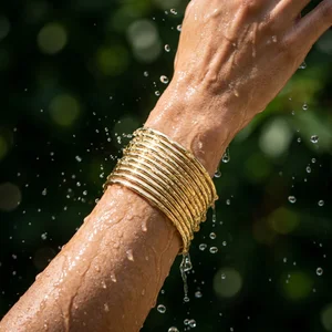 Gold bangles in a water splash